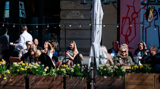 People enjoying the weather outside a restaurant in Stockholm