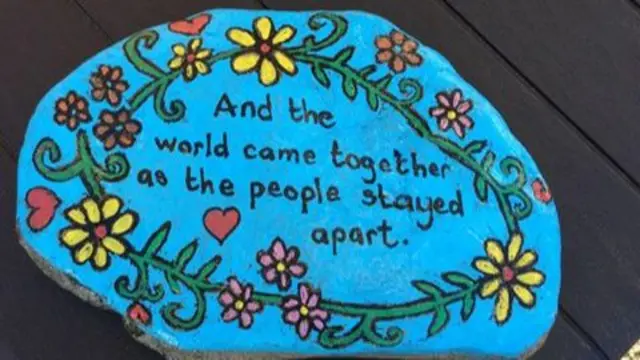 painted stone with message.