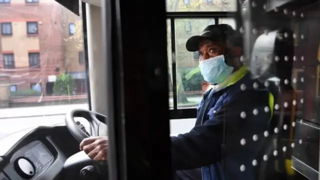 A London bus driver wearing a face mask