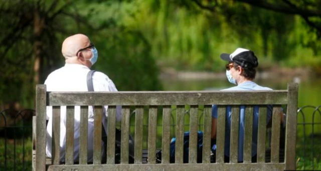 Two people wearing masks