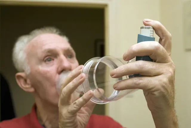 A 71-year-old man uses an asthma inhaler with a volumatic device