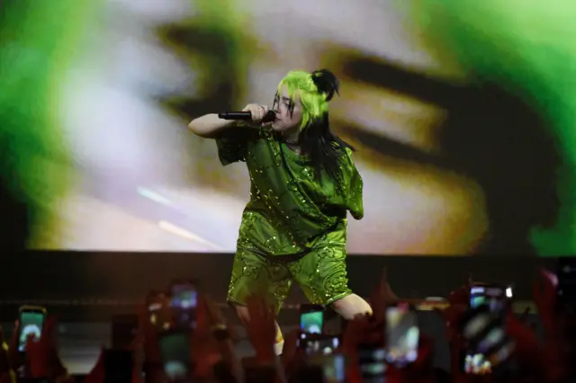 Billie Eilish on stage singing