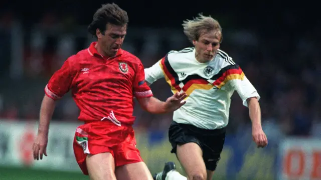 Wales captain Kevin Ratcliffe challenges Germany forward Jurgen Klinsmann