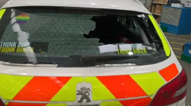 Smashed window of patrol car