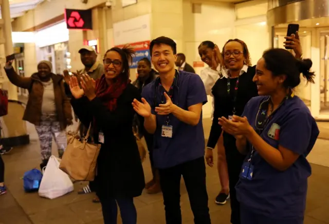 NHS workers applaud on the streets outside Chelsea and Westminster Hospital