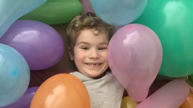 Theo with balloons