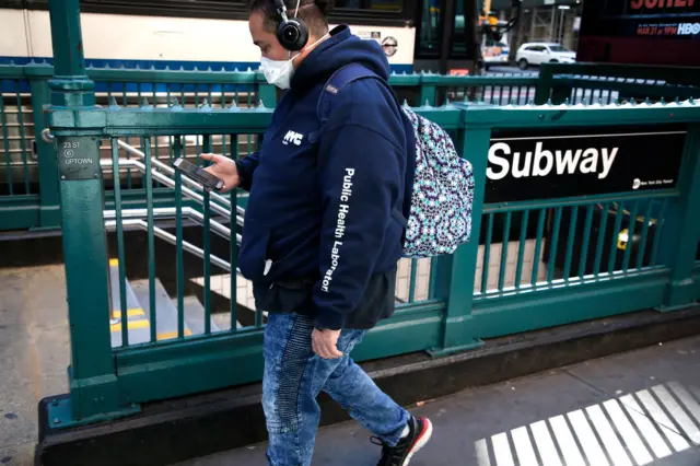 A man walking near a New York subway station