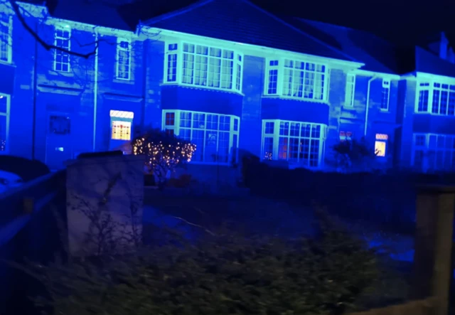 Houses lit up in blue light