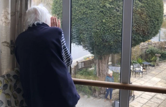 Care home resident watches singer from her window