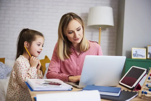 A mother teaching a young girl