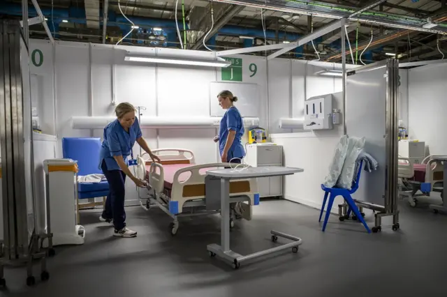 Nurses making a bed at NHS Louisa Jordan hospital