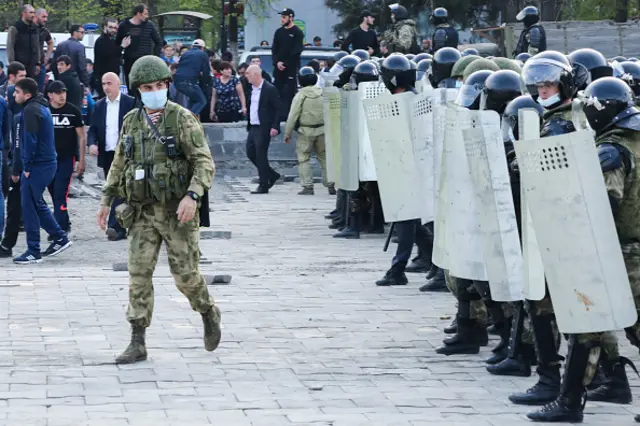 Riot police officers confront participants in a rally against the self-isolation in southern Russia