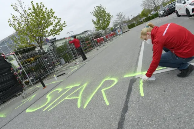 Employees at a hardware store in Germany reopen the shop