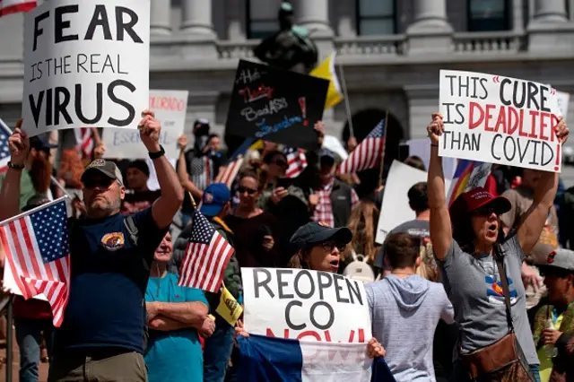 Demonstrators gather in front of the Colorado State Capitol building to protest coronavirus stay-at-home orders