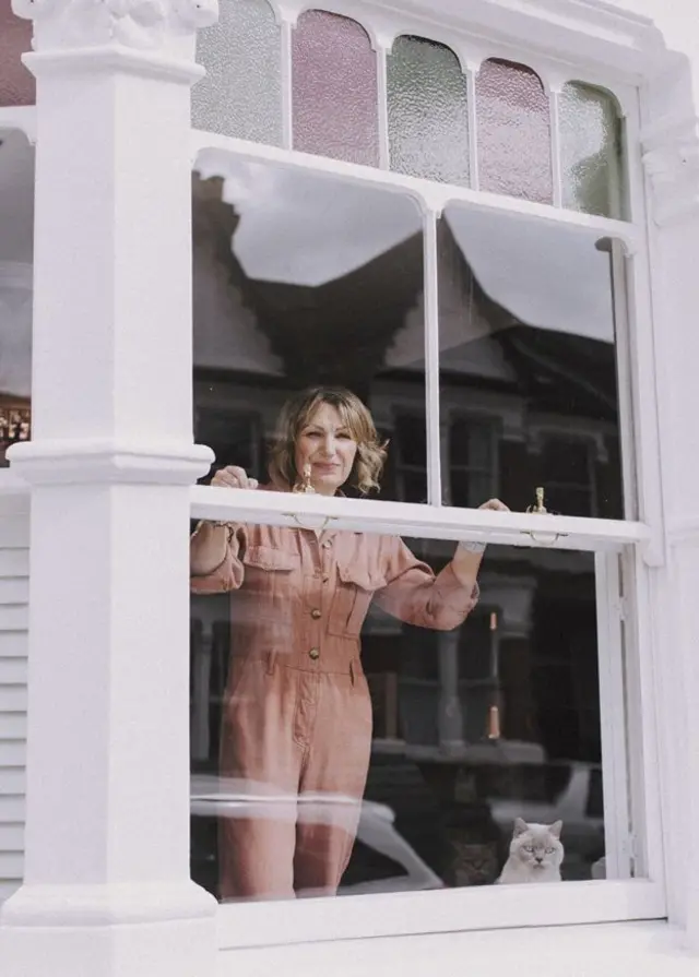 Woman with cats in window