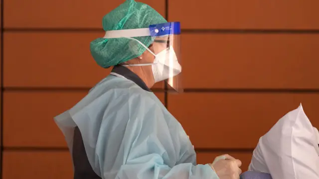 An NHS worker in PPE