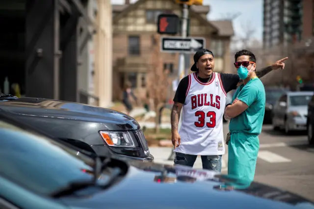 A protester shouts at a healthcare worker