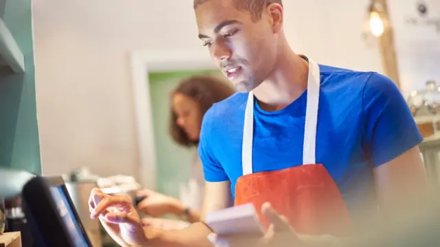 Man using a till