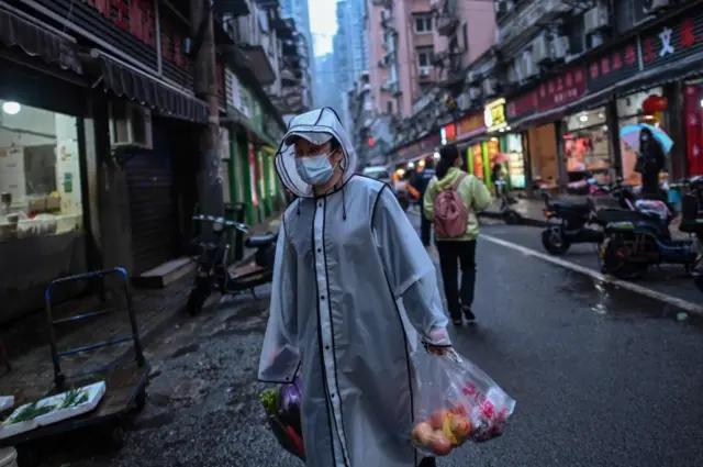 A man wears protective clothing in Wuhan