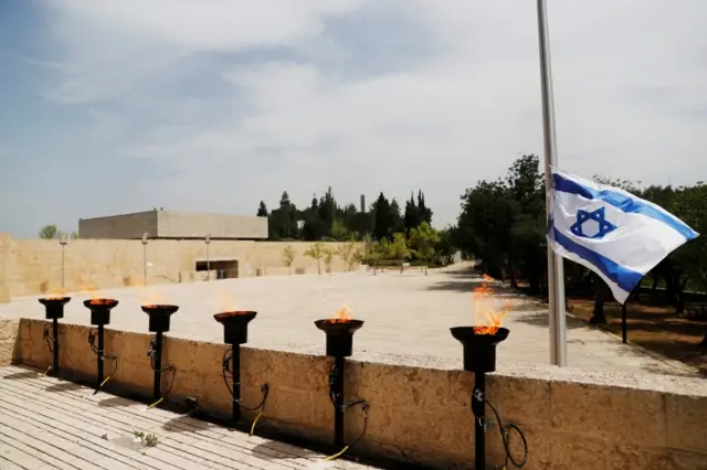 Six torches burn at the Yad Vashem Holocaust memorial centre on 21 April 2020