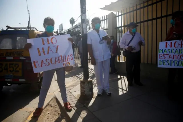 A health worker holding a sign reading "There are no N-95 masks" protests the lack of proper medical supplies outside of Maria Auxiliadora hospital amid the spread of the coronavirus disease (COVID-19), in Lima, Peru April 20, 2020