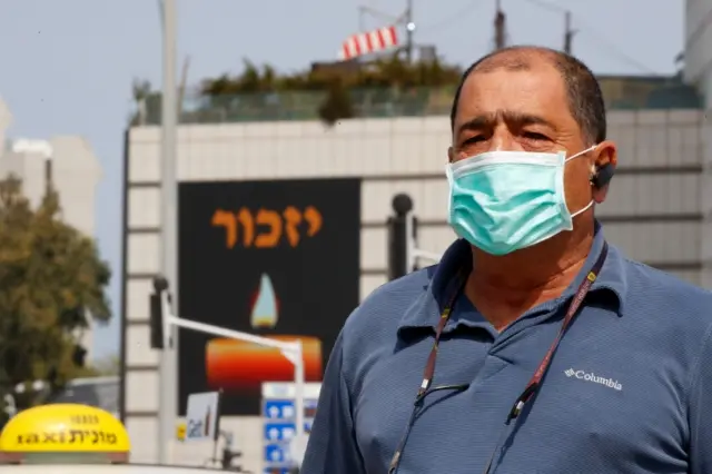 An Israeli man stands in silence to mark Holocaust Remembrance Day in Tel Aviv on 21 April 2020