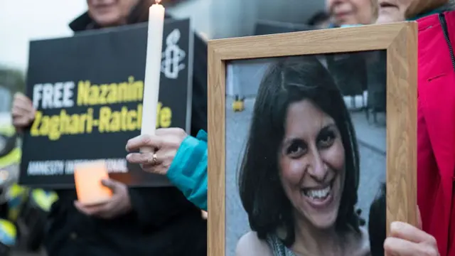 Supporters hold a photo of Nazanin Zaghari-Ratcliffe while calling for her release.