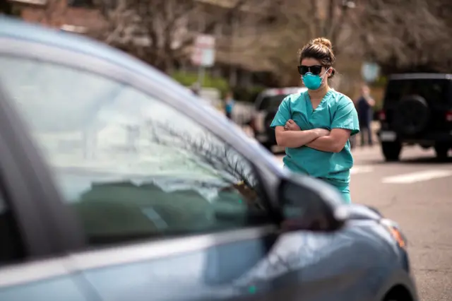 Healthcare workers stand on street during counter-protest