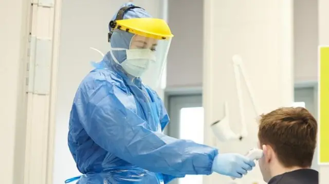 NHS staff member using PPE