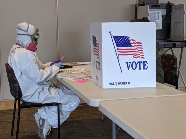 A poll worker in PPE