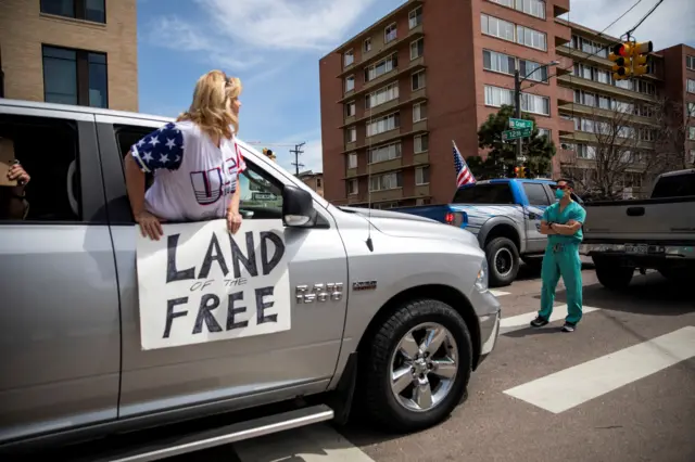 Healthcare workers stand on street during counter-protest