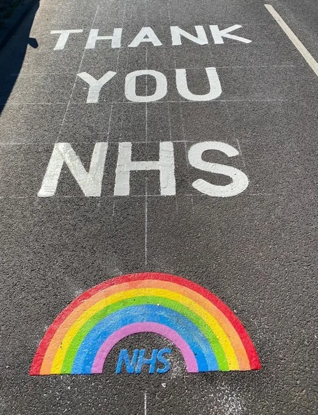 Rainbow sign on road