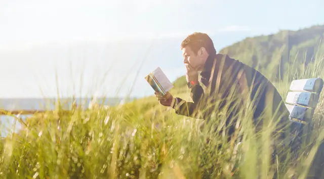 Man reading by the sea