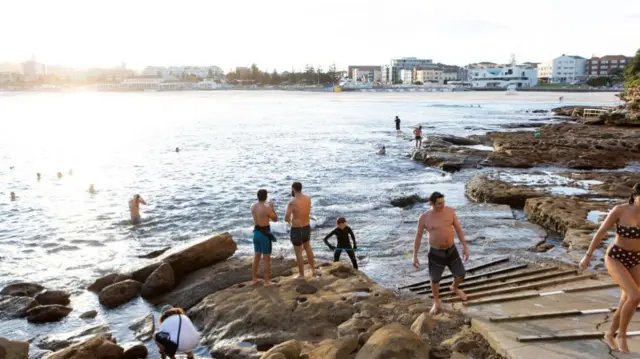 People swimming at North Bondi rocks