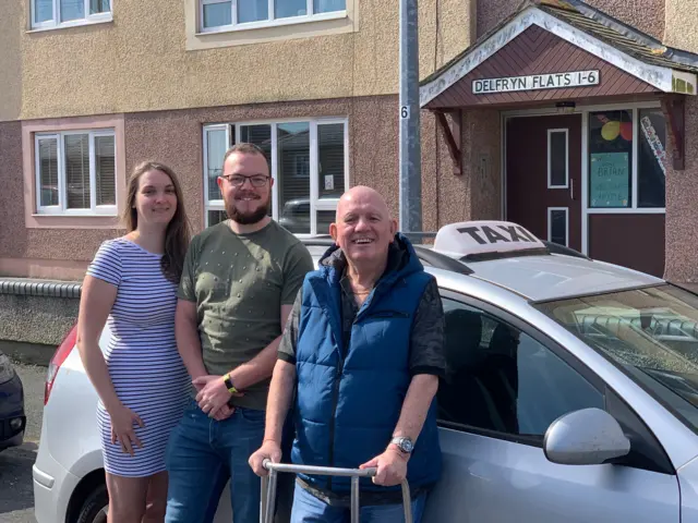 Brian Davies checks up on his taxi with his son Aron and Aron's girlfriend Hayley