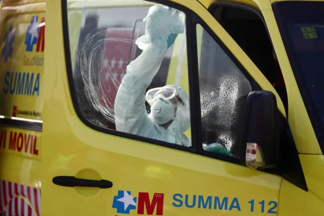 A volunteer firefighter disinfects a Madrid"s Emergency Service (SUMMA) ambulance after transfering a patient suffering from coronavirus disease