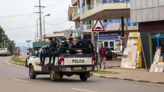 Police officers patrol at an empty street in Kigali, Rwanda