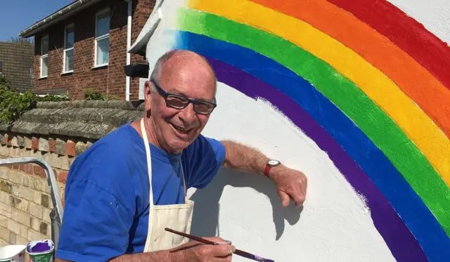 Ron Nix painting a rainbow