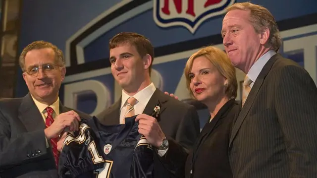 Eli Manning with a San Diego Chargers jersey after being picked first at the 2005 draft