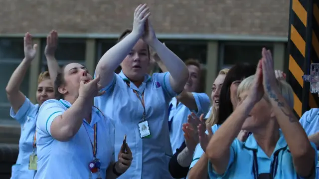 Staff at the Freeman Hospital in Newcastle upon Tyne clap and whistle