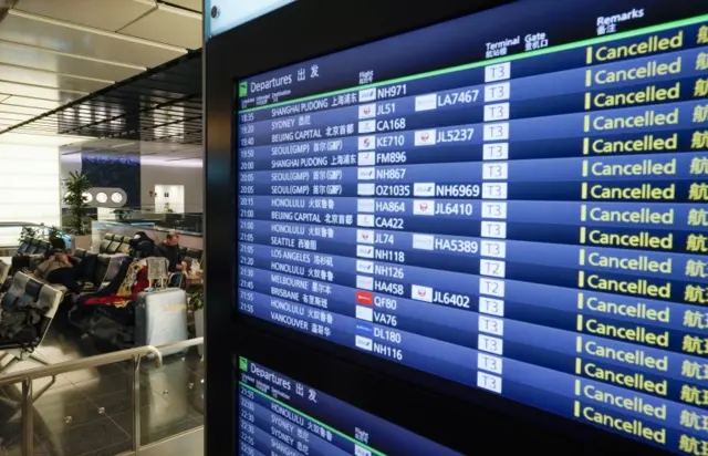 A monitor shows cancelled flights at Tokyo airport, Japan. Photo: 14 April 2020