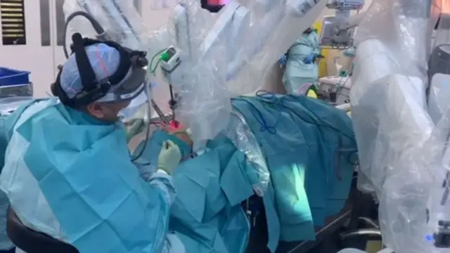 Robotic arm operates on patient