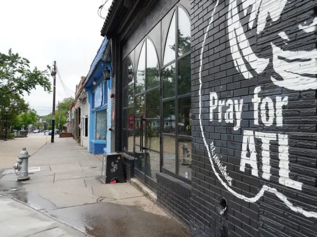 A restaurant has "Pray for ATL" painted on its exterior wall, amid the Covid-19 outbreak