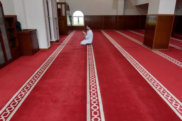 Xhemal Hafizi, Imam of the Tanners' Mosque, prays alone on the first night of the holy month of Ramadan, in Tirana