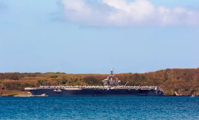 The aircraft carrier USS Theodore Roosevelt is docked at Naval Base Guam in Apra Harbor on 10 April, 2020