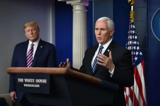 US President Donald Trump looks on as US Vice President Mike Pence speaks during the daily briefing on the novel coronavirus, which causes COVID-19.