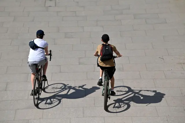 A pair of cyclists take their daily exercise