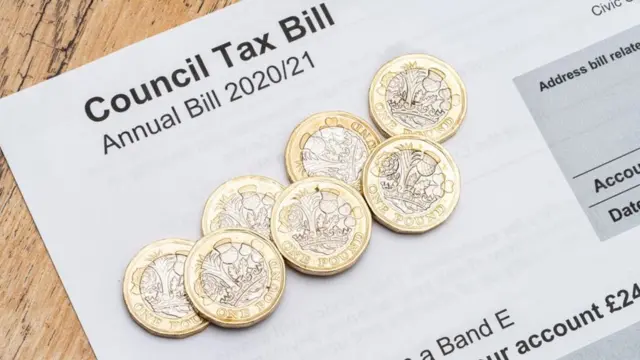 Pound coins on a council tax bill