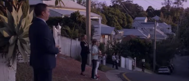 People stand at end of driveways with a candle in an advert for the RSL's Anzac Day 2020 commemoration