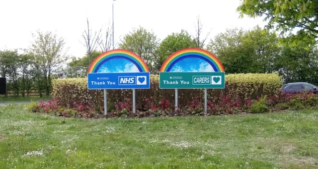 Rainbow signs on the roundabout